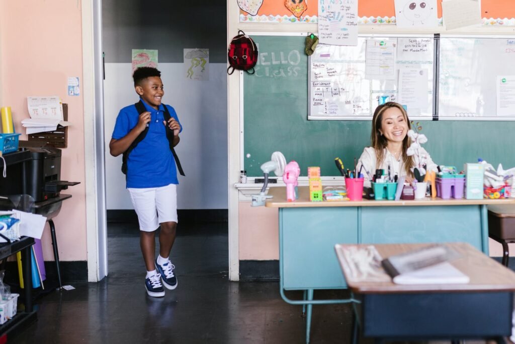 Boy in Blue Shirt with Black Backpack Standing on the Doorway